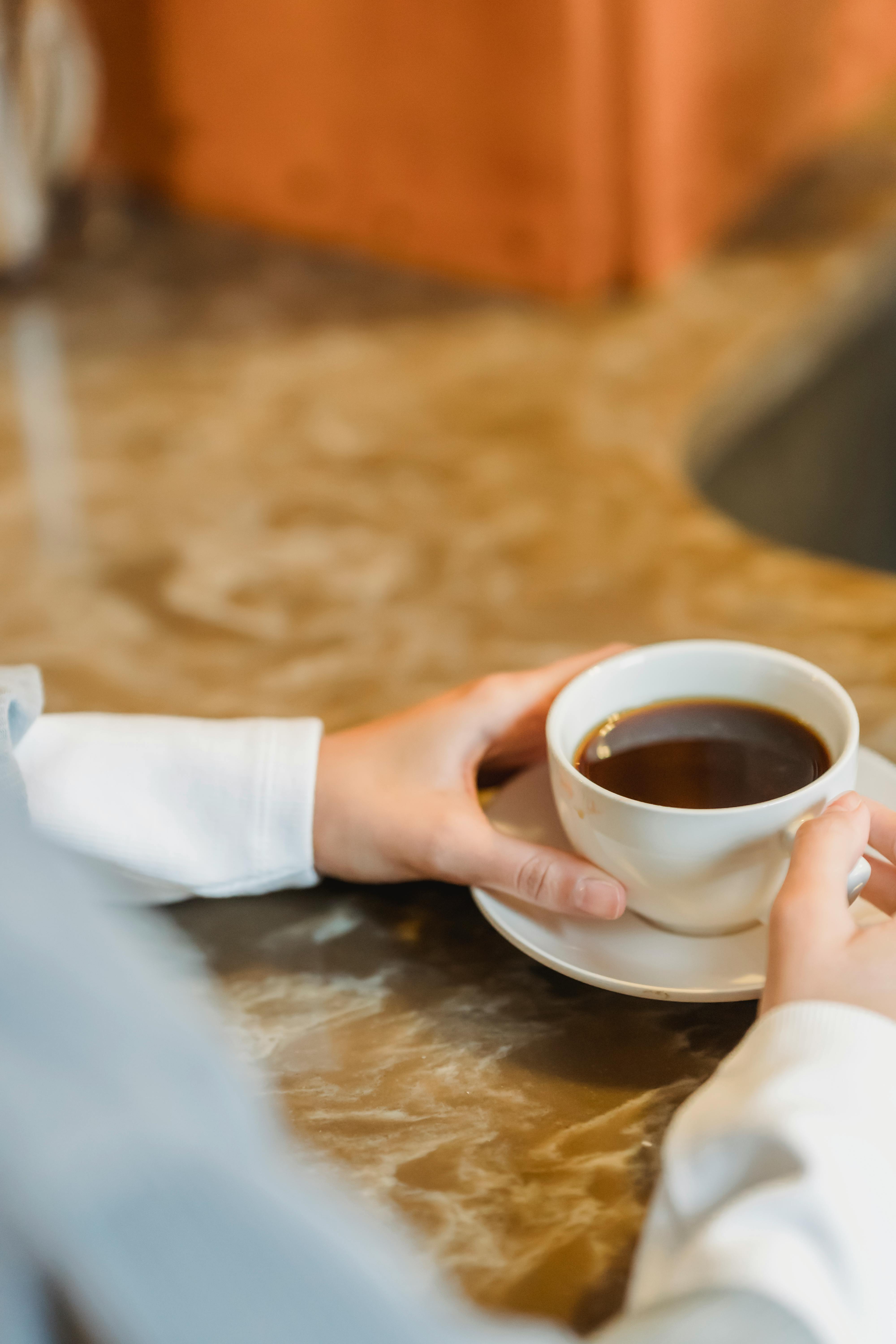 woman with cup of coffee at counter