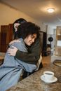 Kind woman comforting black upset girlfriend