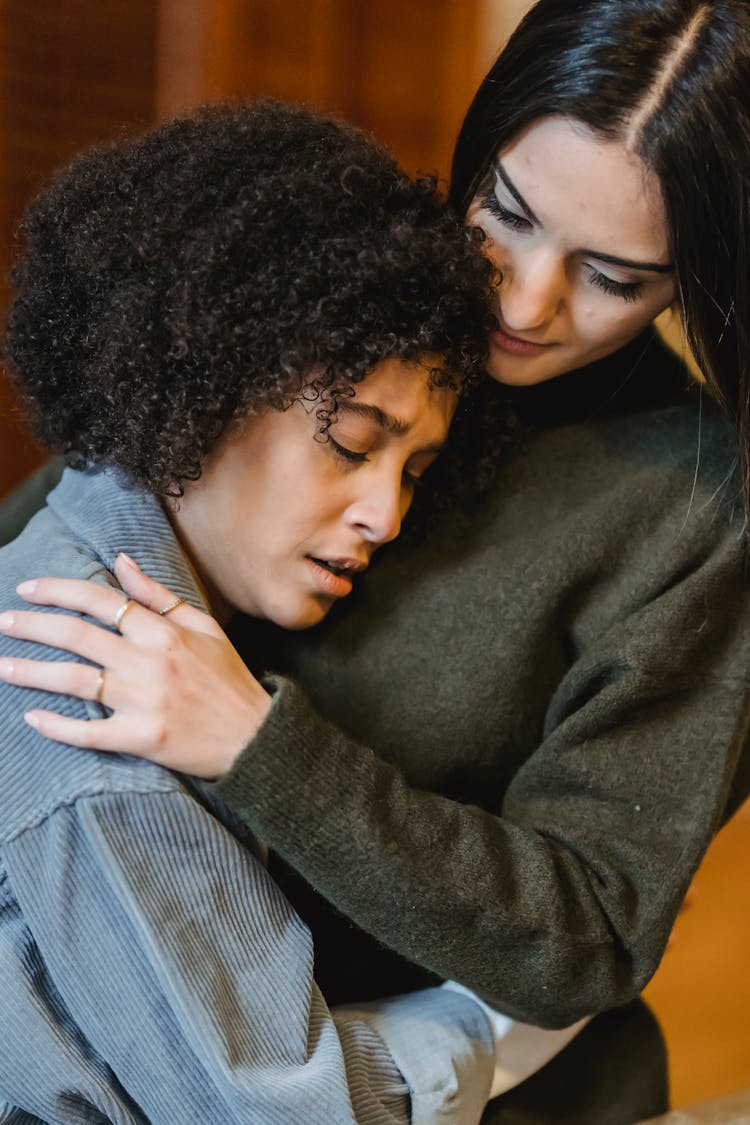 Black Woman Crying On Shoulder Of Friend