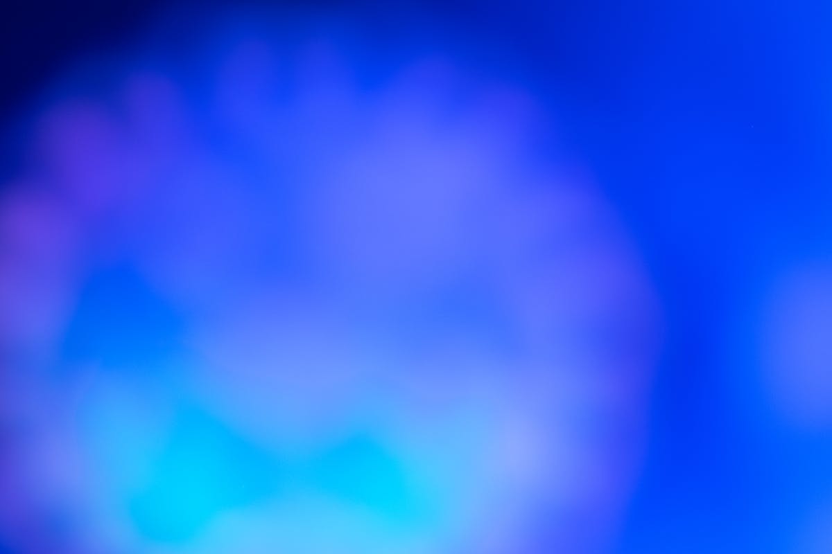 Mother sitting beside a sleeping child in a hospital bed looking tired and worried