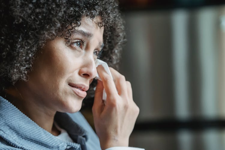 Crying Ethnic Female Wiping Tears With Napkin