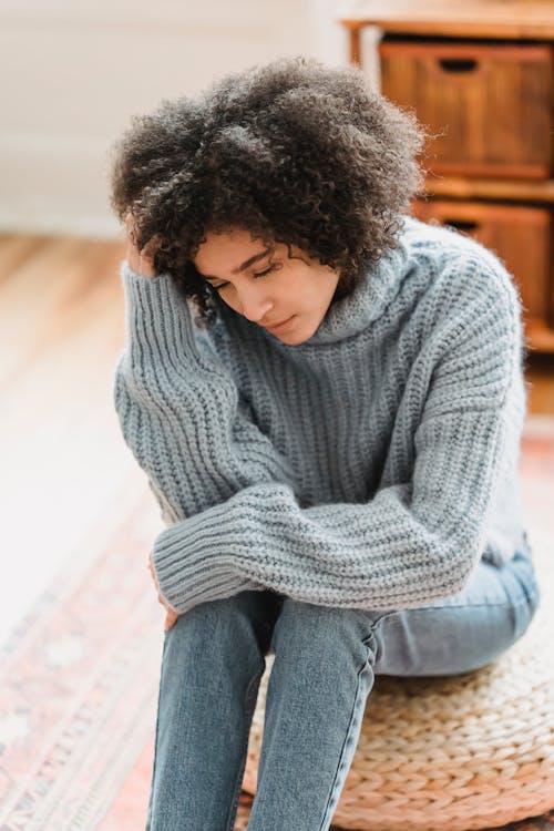 Free Sad black woman sitting in room Stock Photo