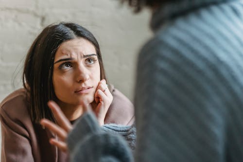 Free Sad woman looking at anonymous woman during conflict Stock Photo