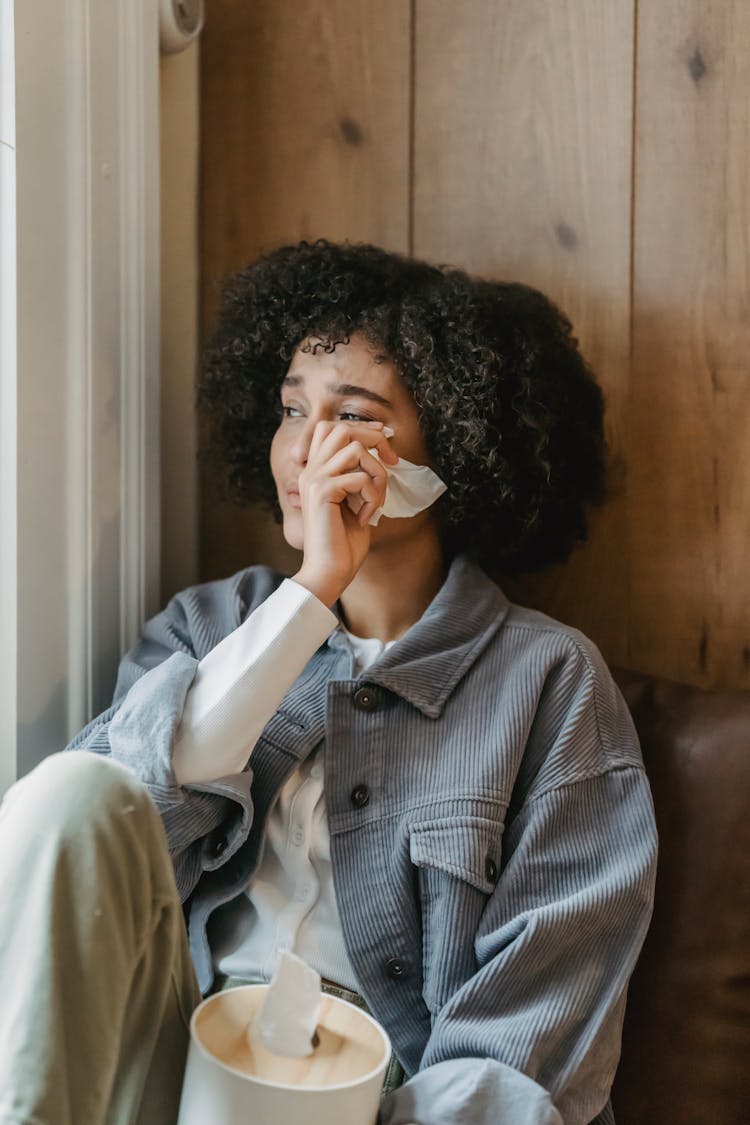 Sad Young Ethnic Lady Crying Near Window At Home