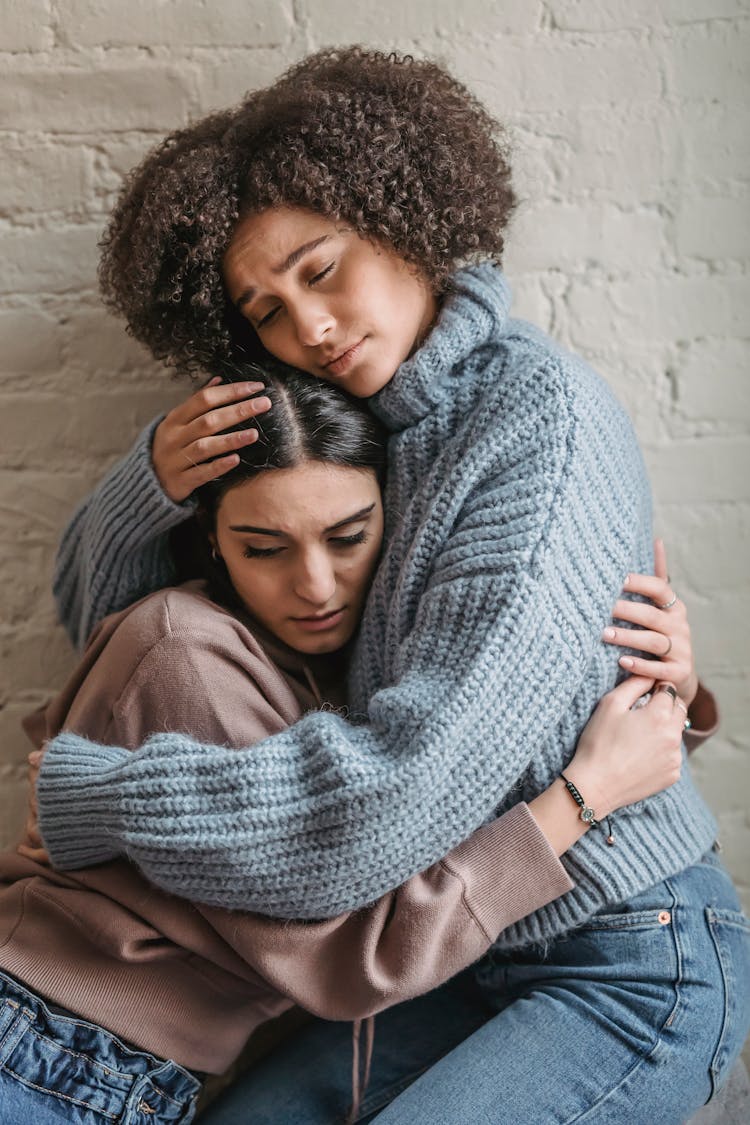 Sad Multiethnic Women Hugging Each Other While Crying At Home