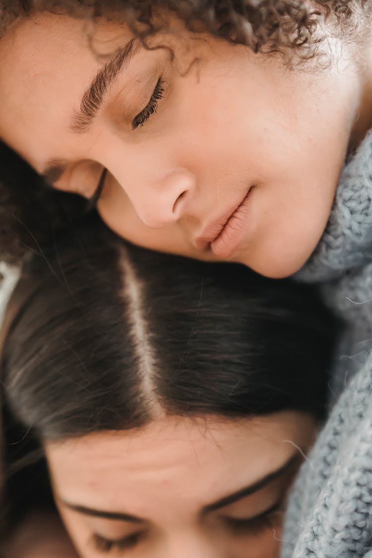 Sad Multiethnic Women Hugging With Closed Eyes