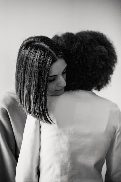 Free Young women hugging after quarrel Stock Photo