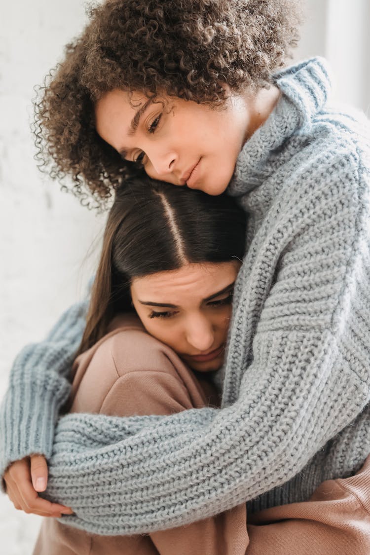 Sad Multiethnic Women Hugging In Room