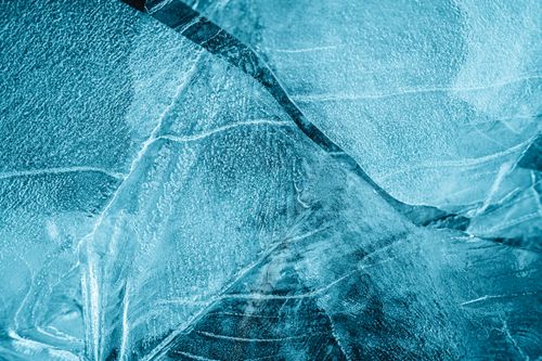 Free From above of frozen crystal water with thin uneven pieces of ice with cracks in daytime Stock Photo