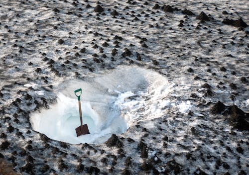 A Shovel on Snow Covered Ground