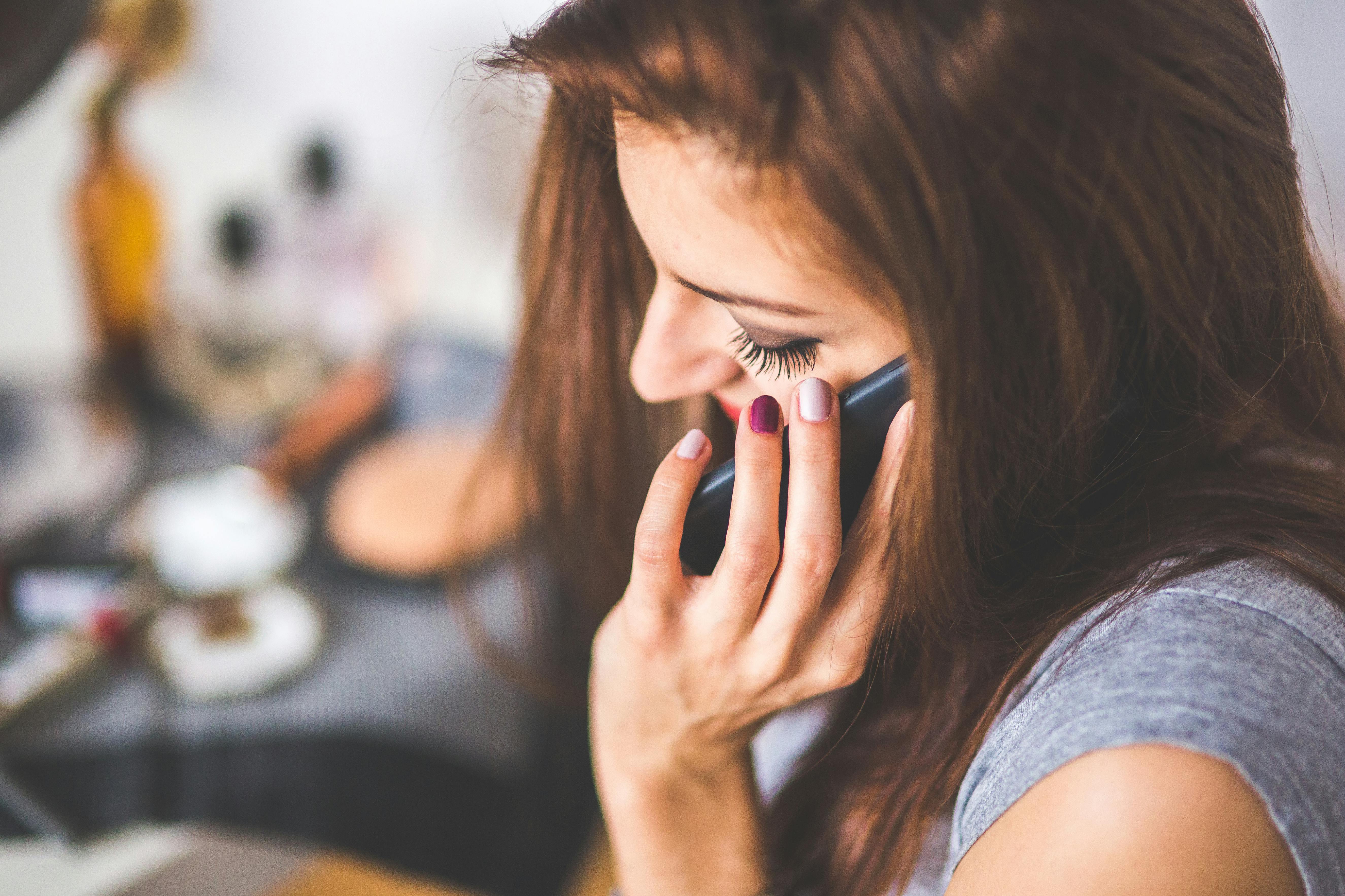 closeup portrait of young lady talking on mobile phone