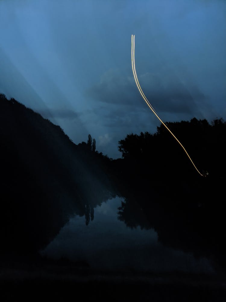 A White Light Streak Over A Lake