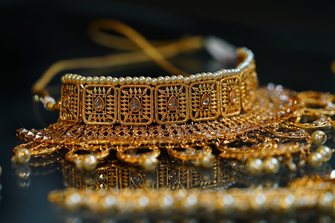 Golden precious oriental jewelry placed on table