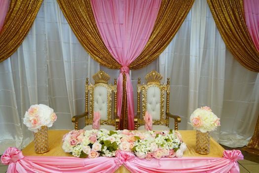 Elegant posh groom and bride table decorated with flowers for wedding celebration in fine restaurant