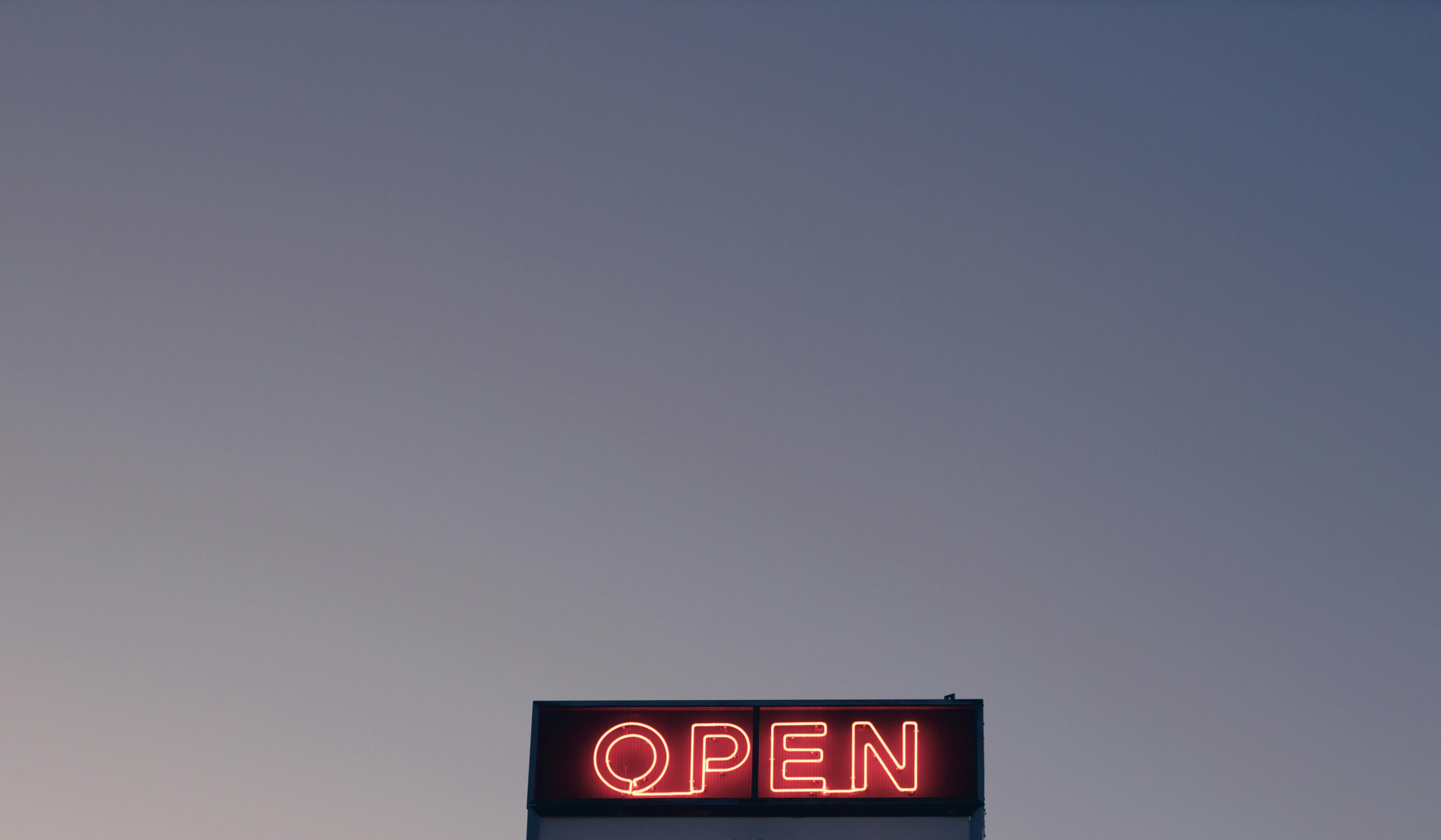 open sign under cloudless evening sky