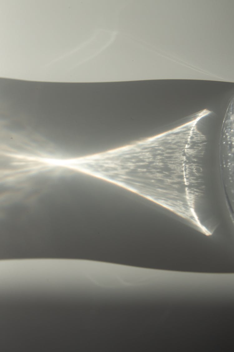 Water Glass Shadow On White Table In Bright Sunlight