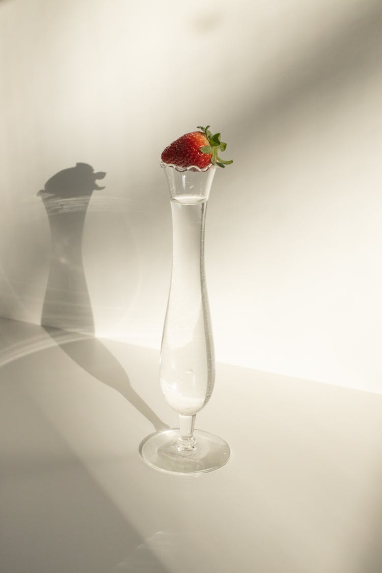 Strawberry Of Glass With Transparent Liquid In Daylight