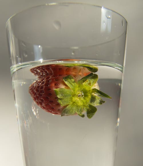 Glass of refreshing cocktail with strawberry