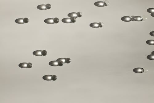 Shiny small balls scattered on table in light studio