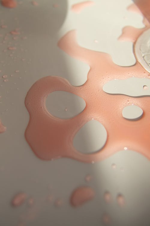 Red colored juice spilled on white surface