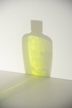 Shade of transparent bottle with yellow gel and smooth surface with  gray spots