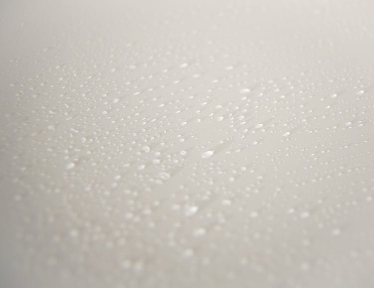 Textured Background Of Water Drops On White Surface