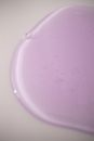 From above of abstract backdrop of pale purple gel blot with smooth surface on white background