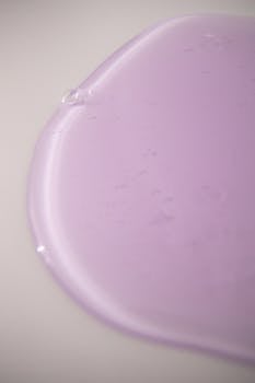 From above of abstract backdrop of pale purple gel blot with smooth surface on white background