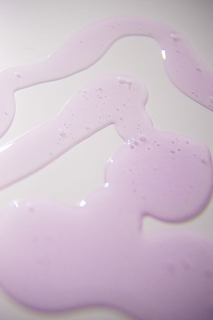 High angle of textured backdrop representing smooth gel fluids with tiny bubbles on white background