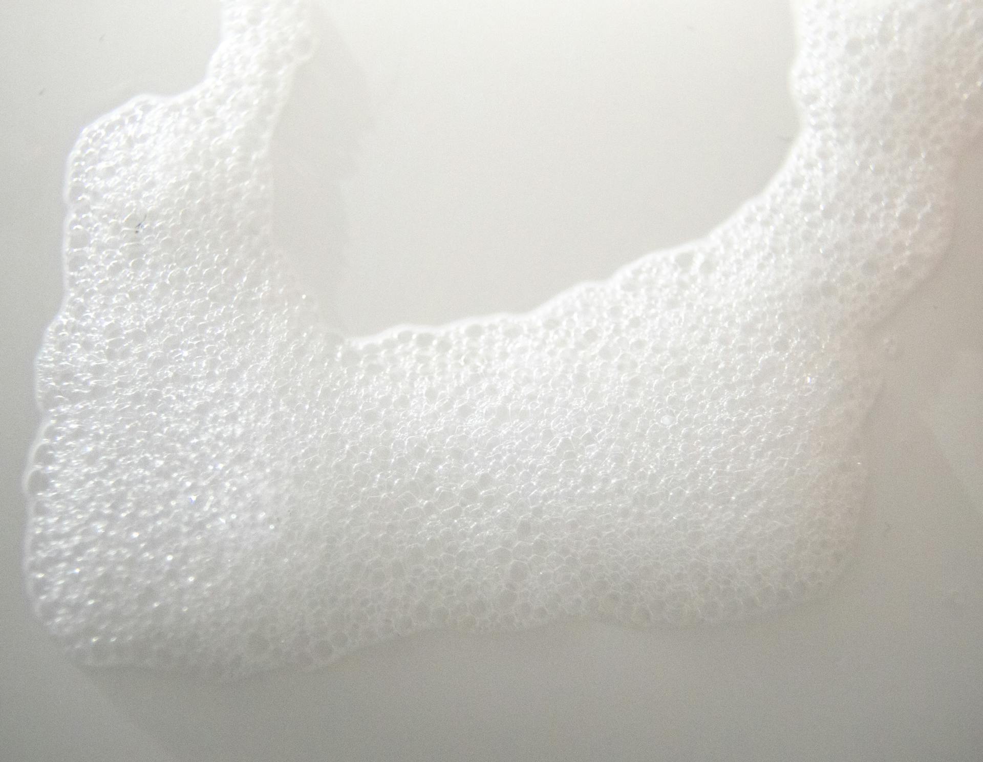 Abstract background of white foam on smooth surface