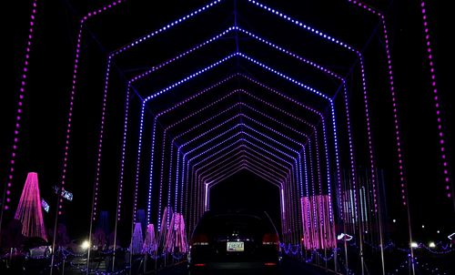 Free A striking display of colorful LED lights forming a tunnel structure at night in Tempe. Stock Photo