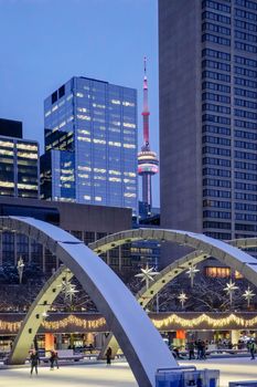 Enjoy winter skating under the iconic arches of Nathan Phillips Square in Toronto with the CN Tower in the backdrop.