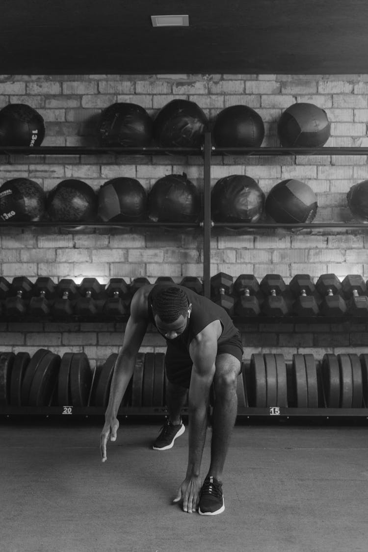 A Man In Black Tank Top Doing Half Lunges