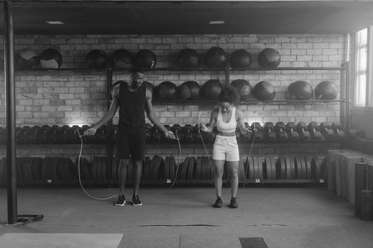 A Man And A Woman Working Out With Jump Ropes