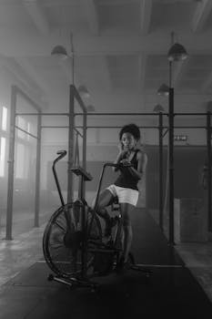 African American woman exercising on stationary bike in gym