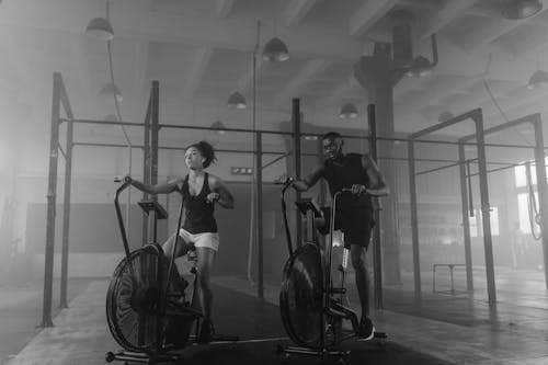 A Couple Exercising on Air Bikes