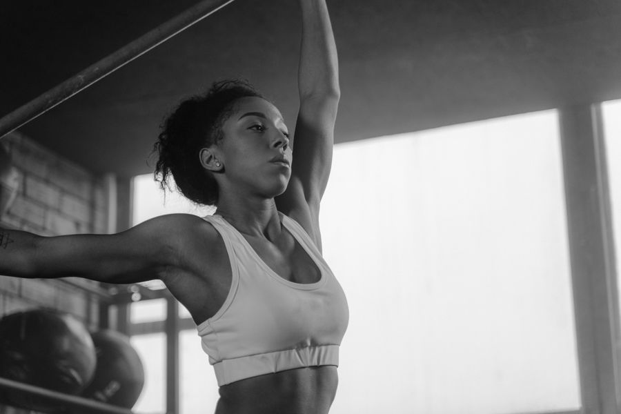 A black-and-white portrait of an athlete mid-stretch — photo by Tima Miroshnichenko on Pexels