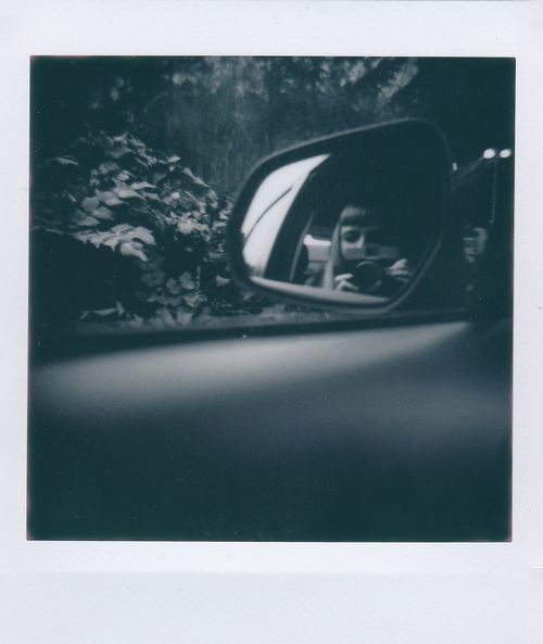 Free Grayscale photo capturing reflection in car side mirror, artistic perspective. Stock Photo