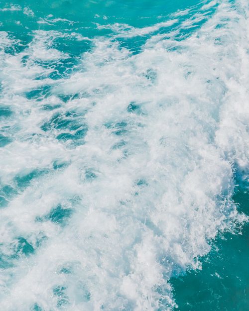 Free Vivid turquoise ocean waves crashing dynamically against each other, creating a serene and energetic atmosphere. Stock Photo