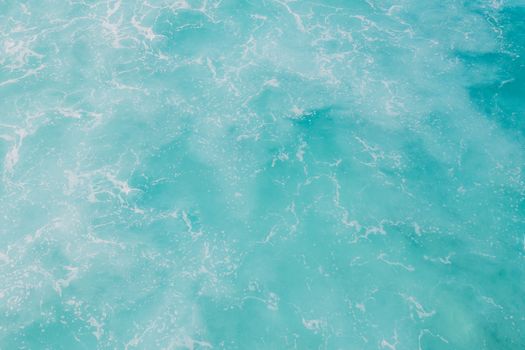 A soothing view of turquoise ocean waves forming natural, artistic patterns.