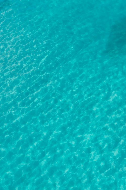 Free Vibrant turquoise ocean water viewed from above, showcasing natural beauty. Stock Photo