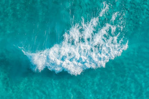 High Angle Shot of a Blue Ocean with White Seafoam
