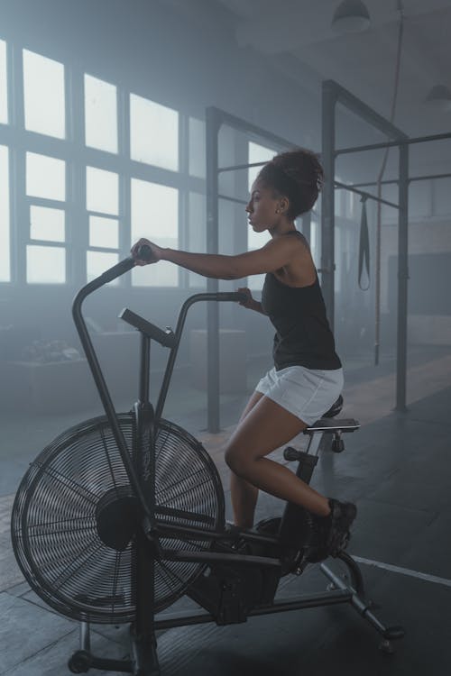 Free A Woman Exercising on an Air Bike Stock Photo