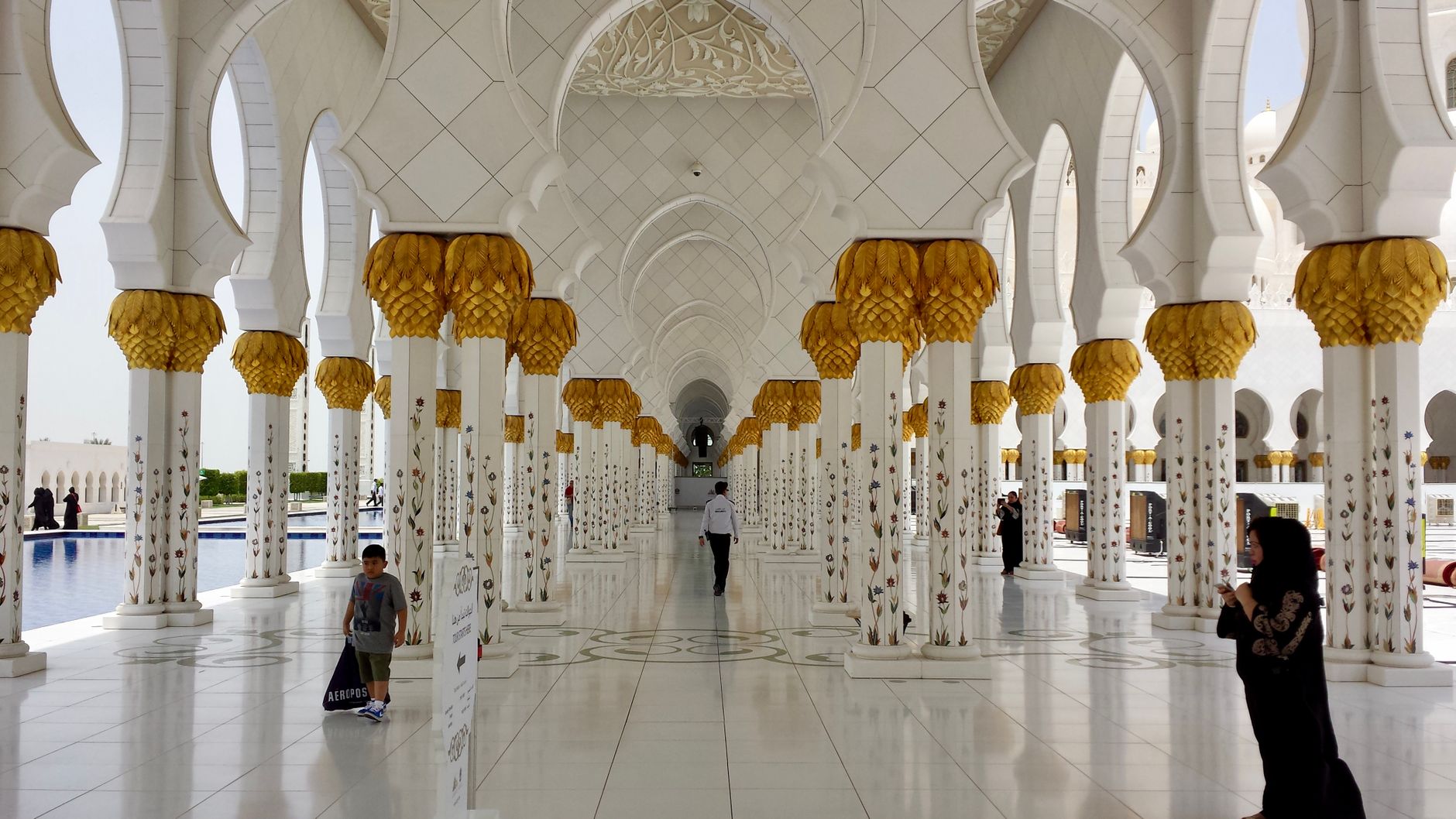sheikh zayed grand mosque abu dhabi white marble dome columns interior carpet