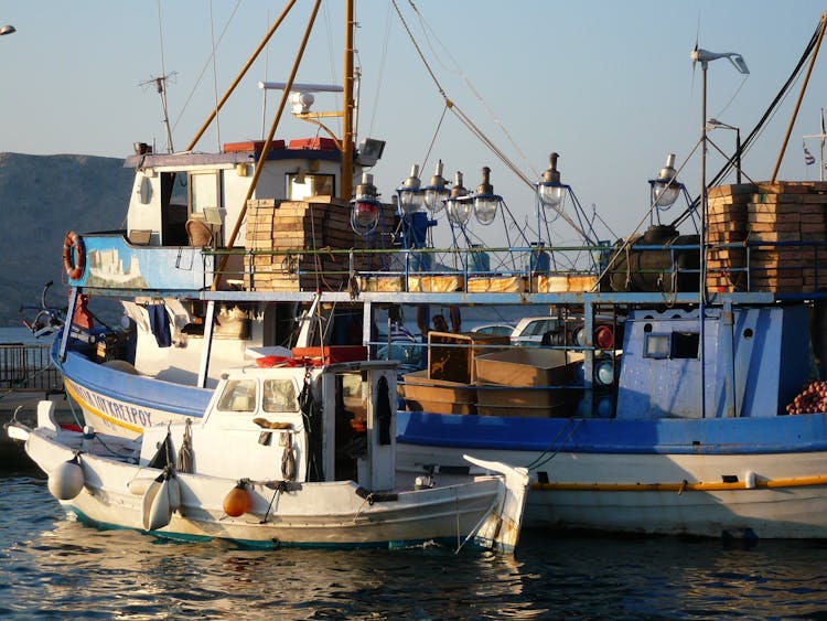 Old Trawler And A Fishing Boat Moored In Harbor