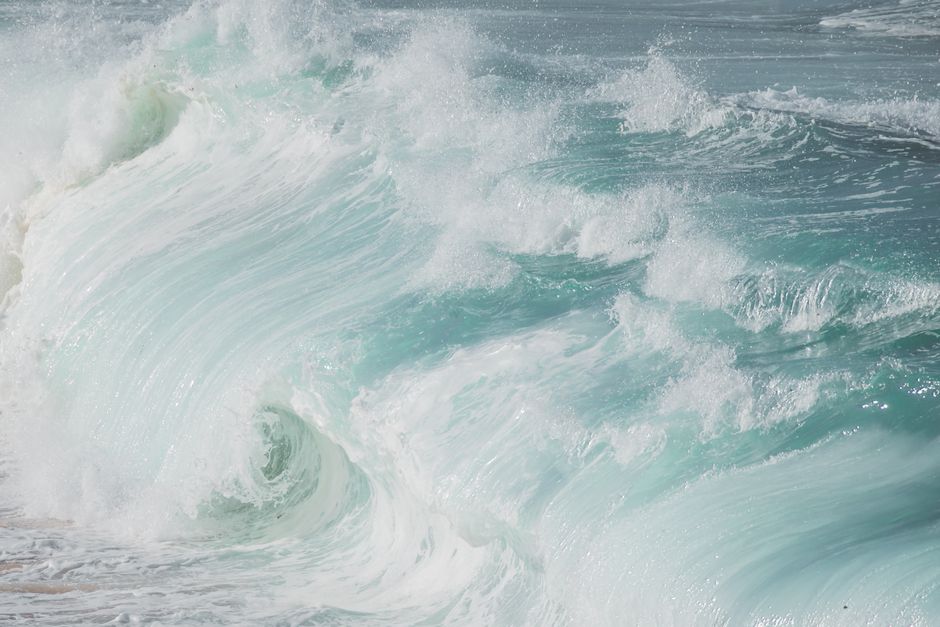 Close-up of powerful ocean waves crashing with foamy splashes, capturing the essence of natural motion.