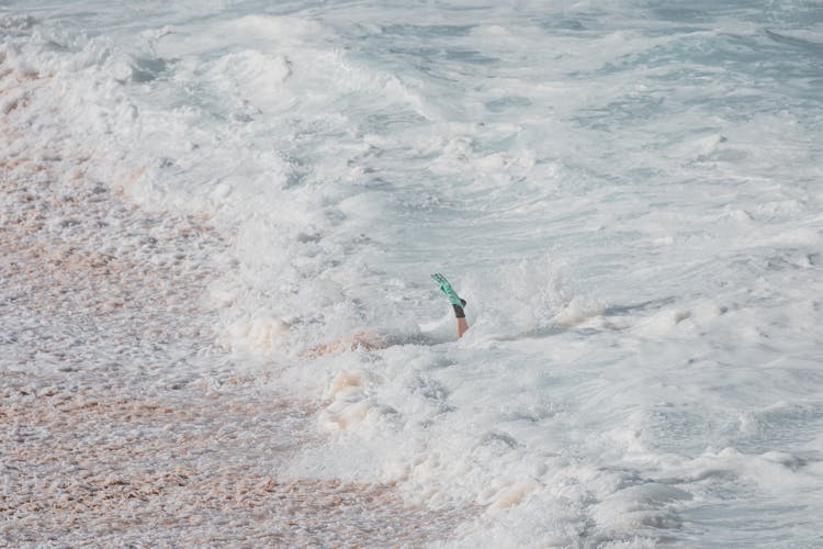 Person's Foot In The Water