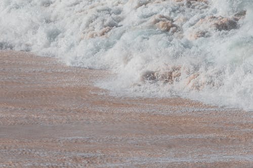 Close-up of Foamy Waves on a Beach