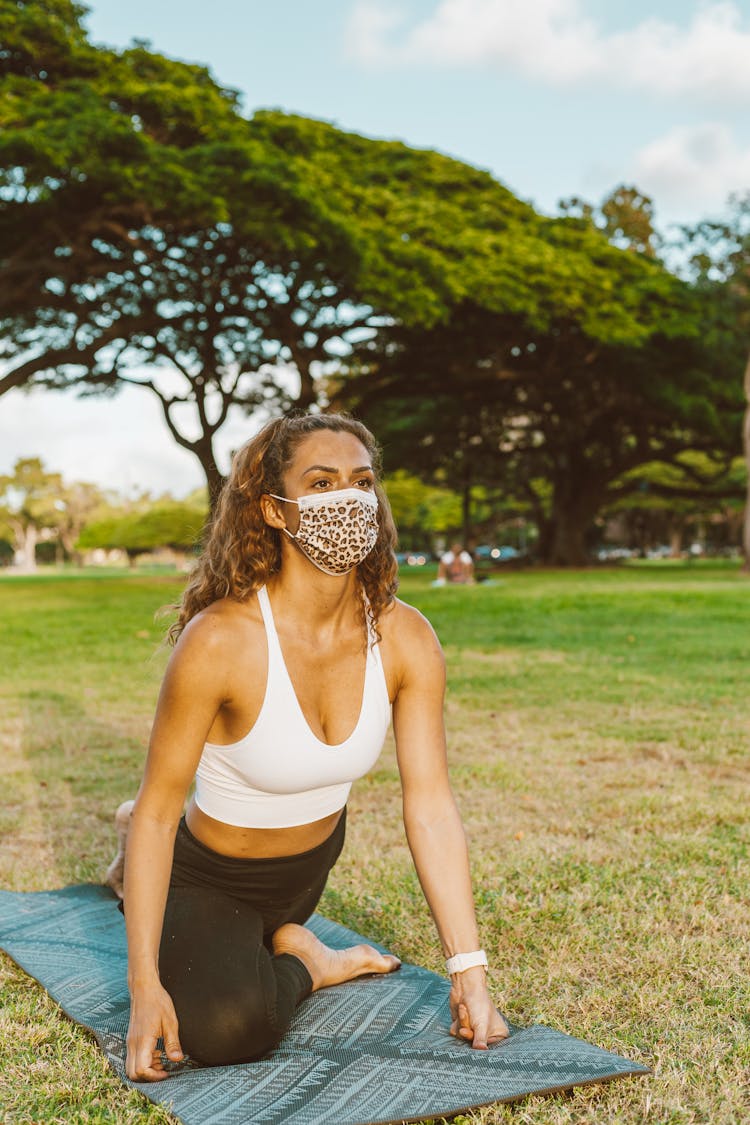 Young Woman In Mask Performing Yoga Stretching Exercise