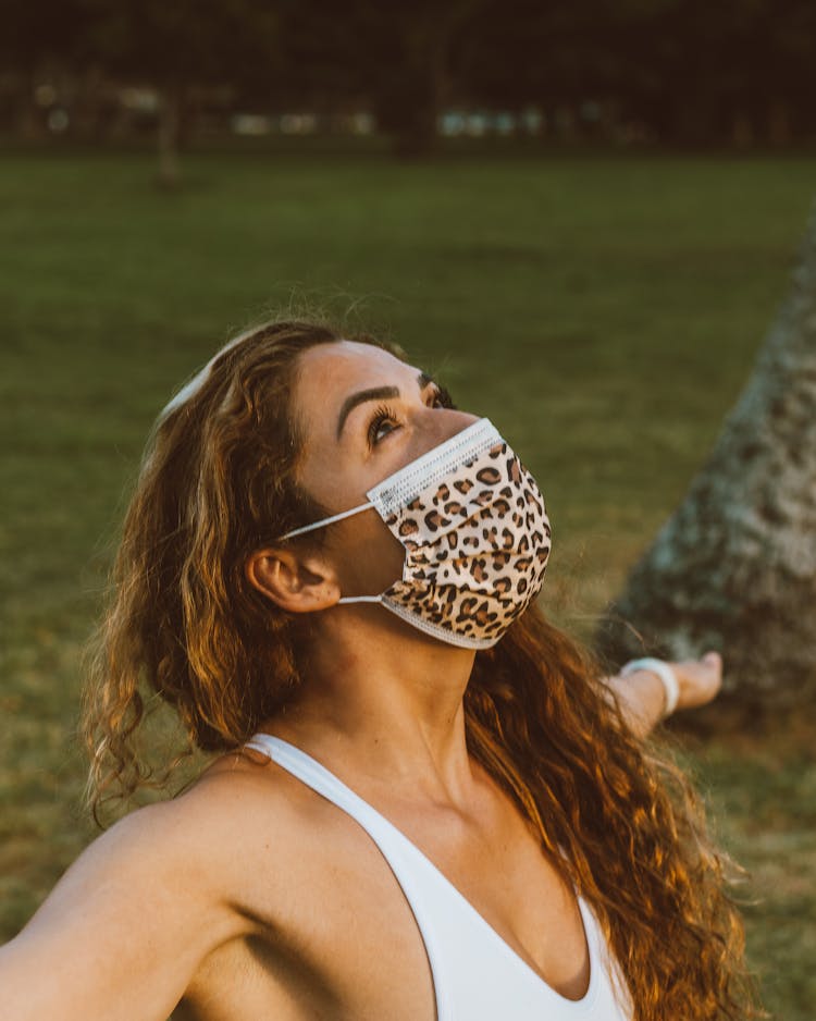 Woman With Mask On Face Standing With Hands Stretched Out To Side